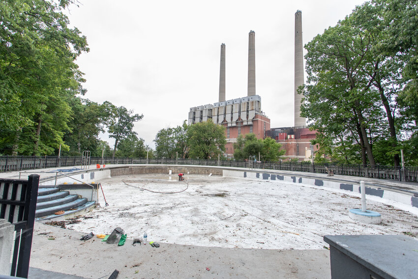 A worker power washing the inside of the Moores Park Pool to remove grit and grime that's accumulated since it closed in 2019. The pool is expected to reopen by 2026.