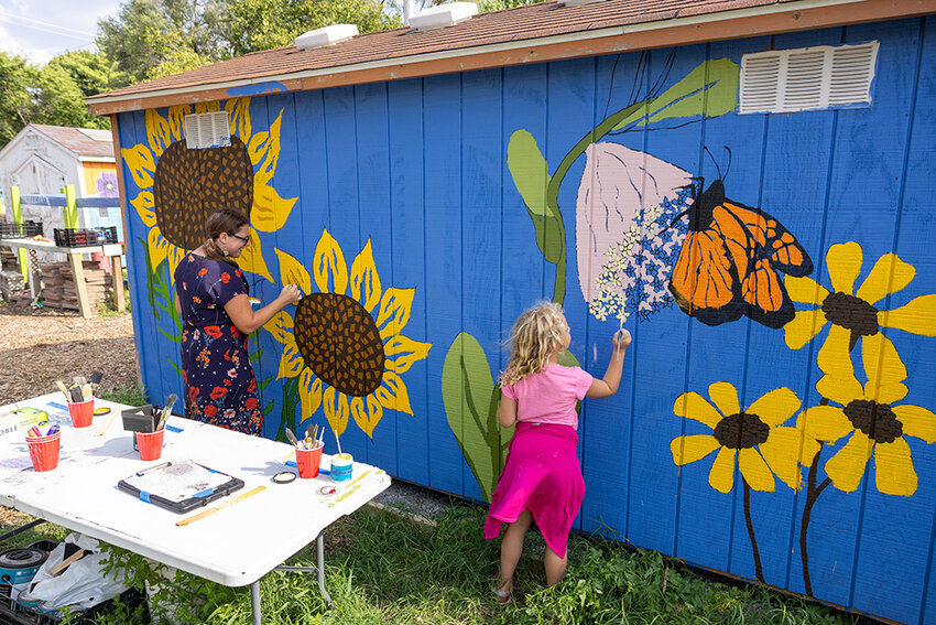 Courtesy Ethan Schmitt of the Allen Neighborhood Center  Eastside residents Egypt Krohn and her daughter Eowyn paint a garden shed at Hunter Park.