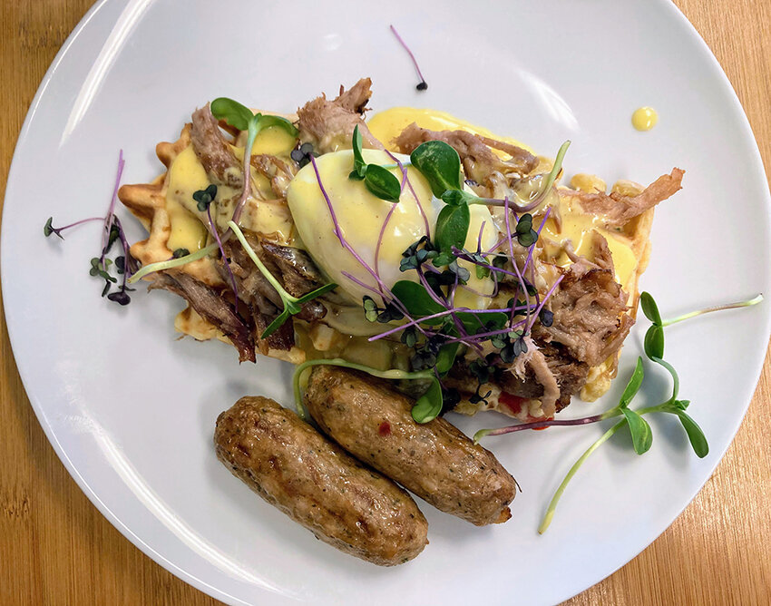 Lizy Ferguson for City Pulse
That New Place’s savory root vegetable waffle is topped with a light and creamy Hollandaise sauce and tender bo ssam pork.