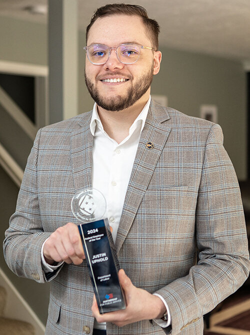 Raymond Holt for City Pulse  Grand Ledge resident Justin Uphold with his award as federal government employee of the year for his role in uncovering abuses of young workers in meat-packing plants.