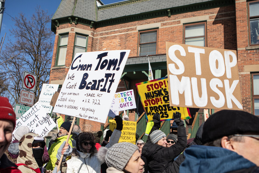About 100 protesters organized by the grassroots organization Indivisible Michigan 7 outside the downtown office of U.S. Rep. Tom Barrett, D-Charlotte, today.