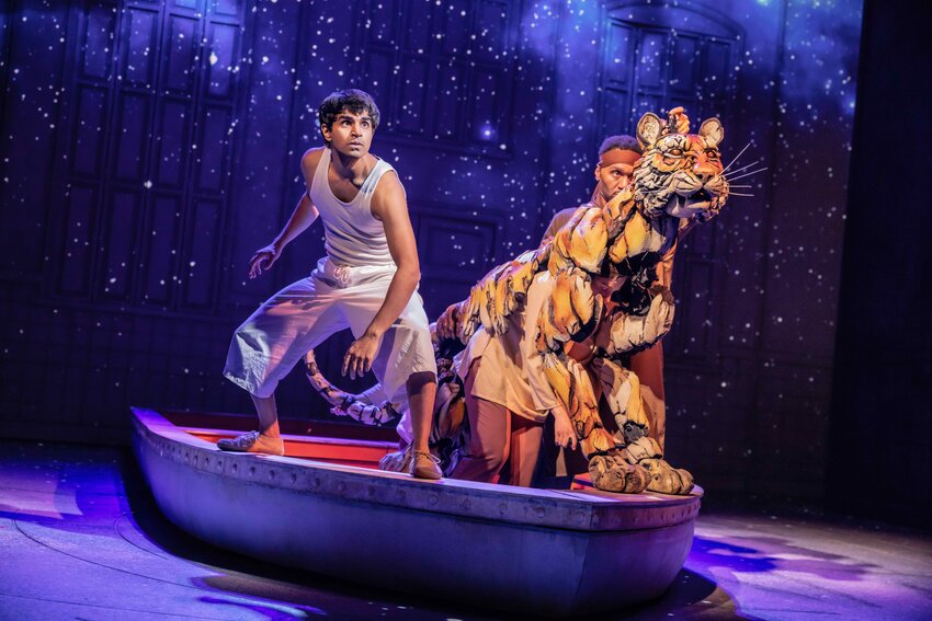 Taha Mandviwala (left) as Pi Patel and puppeteers Anna Leigh Gortner, Shiloh Goodin and Toussaint Jeanlouis as Bengal tiger Richard Parker in the national tour of &quot;Life of Pi.&quot;