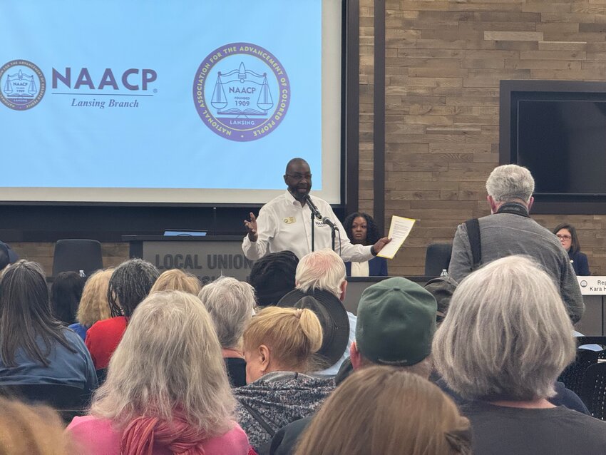 Lansing NAACP Branch President Harold A. Pope addresses a packed room in the United Association Local 333 Plumbers &amp; Pipefitters union hall.