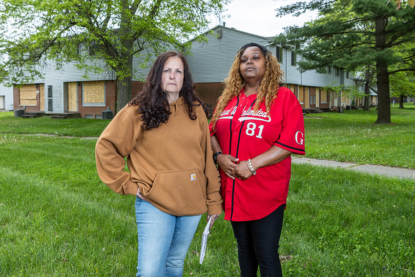 Jodi Kamae (left) and DeEldra (who declined to give her last name) stand in front of Sycamore Townhomes. The residents are among around 70 who were given a 30-day notice to evacuate or face eviction to make way for $15 million in repairs. Fifty still need homes.