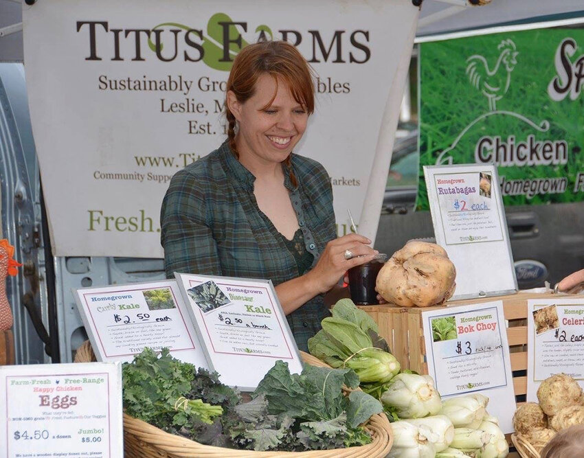 Courtesy photo
Rebecca Titus, owner and CSA manager of Titus Farms in Leslie, feels at home behind the counter at area farmers markets. She’s been attending them with her parents, the farm’s co-founders, since she was an infant.