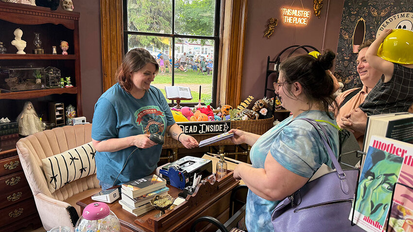 Jenn Carpenter chats with a customer at her new Deadtime Stories location in Charlotte&rsquo;s Courthouse Square Museum.