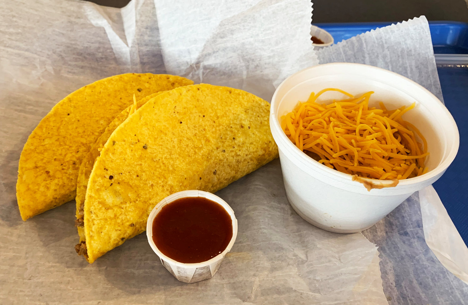Two hard shell tacos with a side of beans from Mr. Taco.