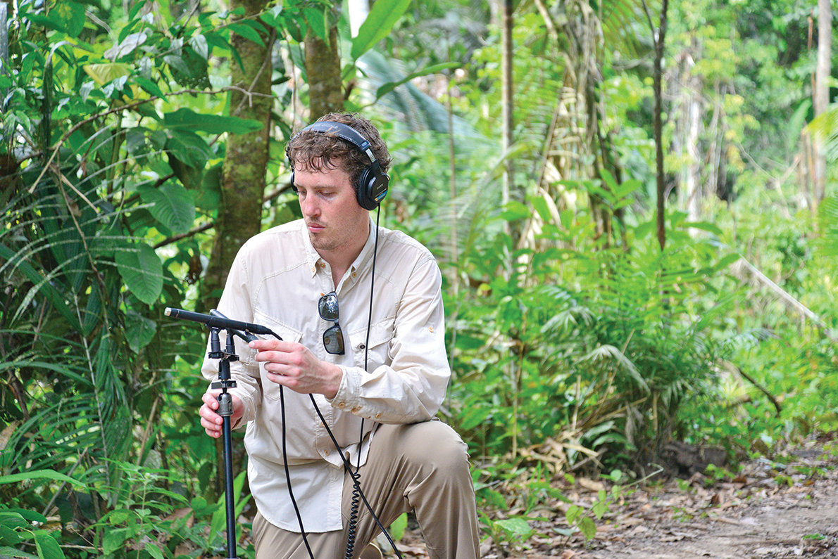 Composer Partick Harlan collecting natural sounds under a jungle's canopy to use as inspiration for a future symphony.