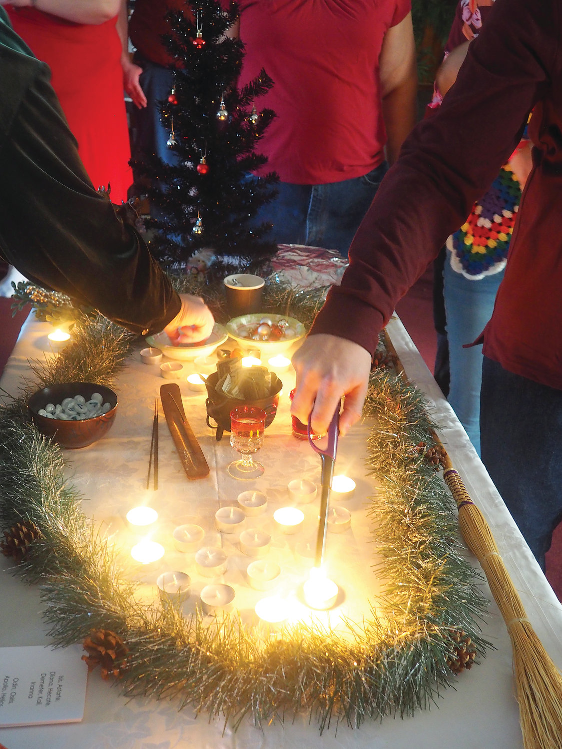 Churchgoers light a candle on the shrine, a practice calling for reflection on the past year.