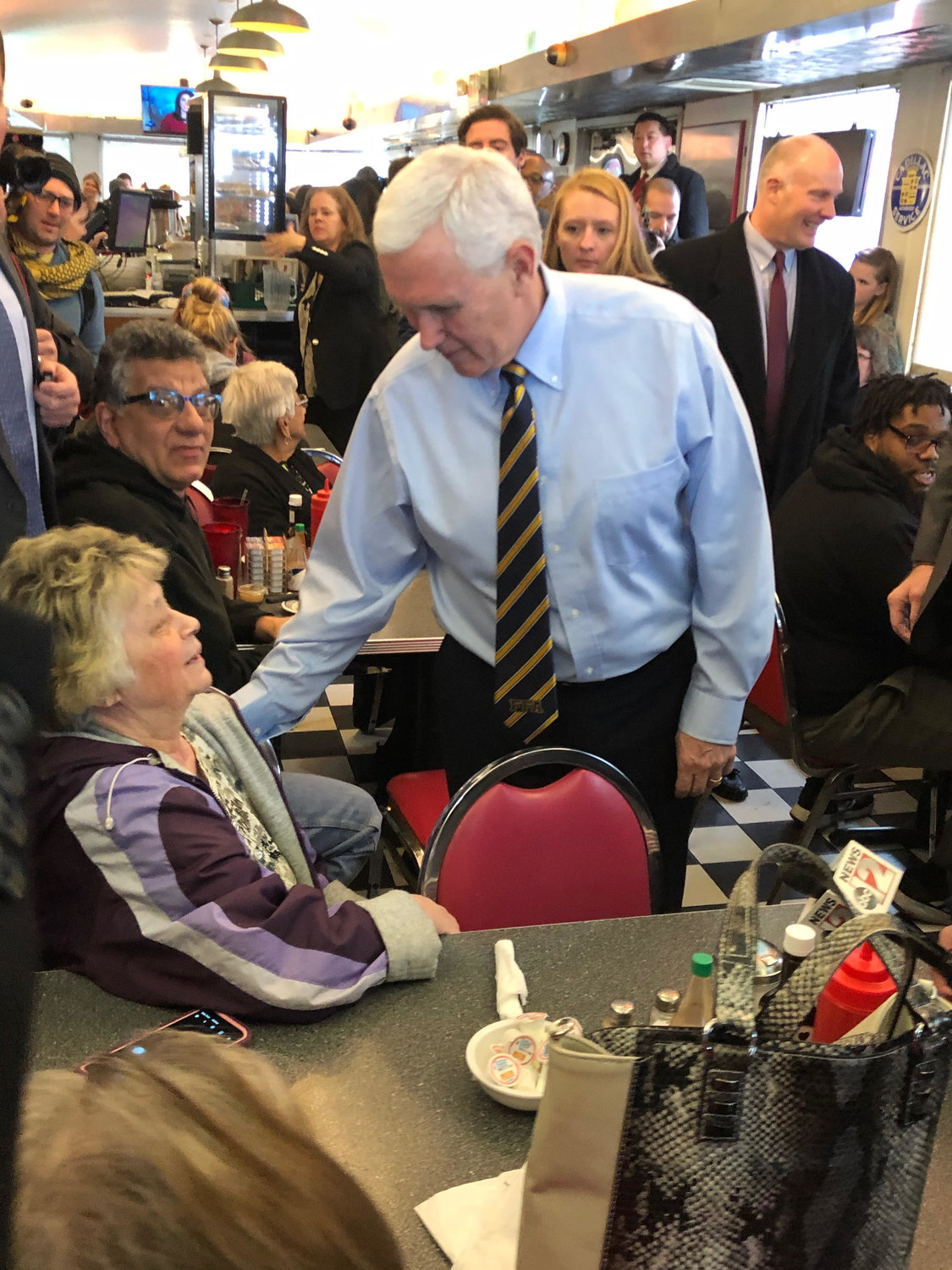 Vice President Mike Pence greets a woman at Fleetwood Diner in Lansing.
