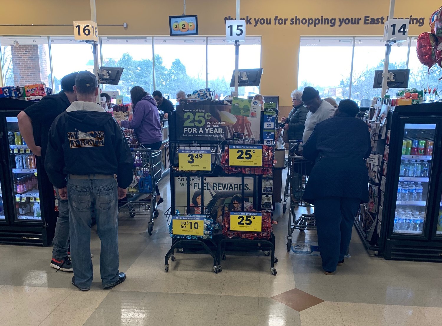 Several customers were standing closer than six feet apart at a Kroger in Lansing on Wednesday.