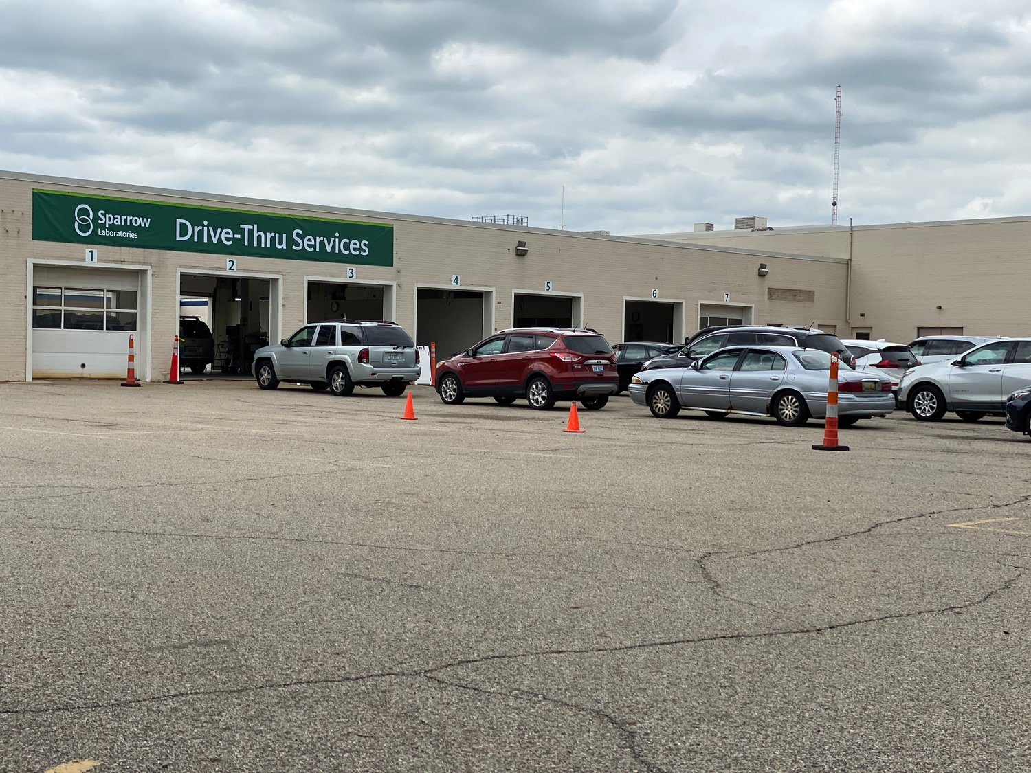 Cars were lined up today almost to Michigan Avenue at Sparrow Health System's new COVID-19 testing site in the old auto repair shop of Sears in Frandor.