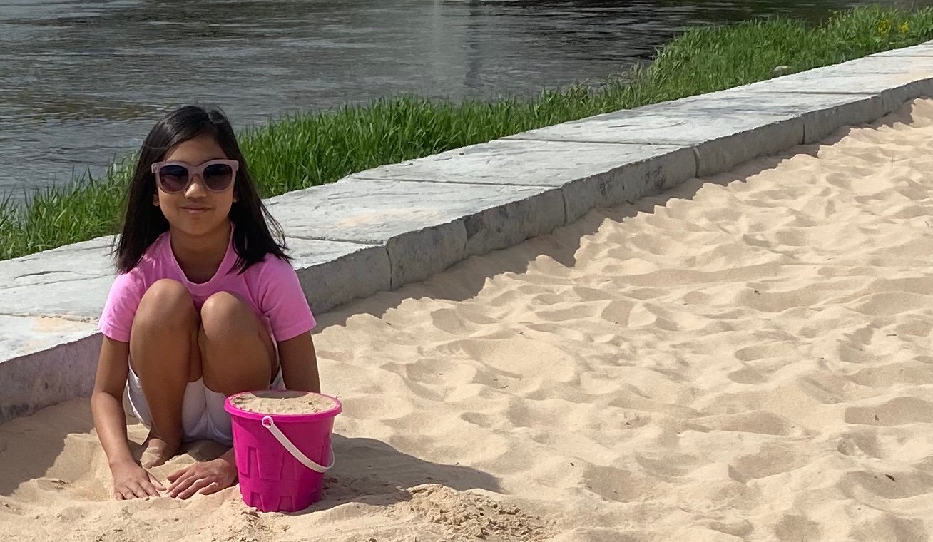 BEACH DAY: A visitor to Rotary Park, in downtown Lansing, enjoys the sand this afternoon.