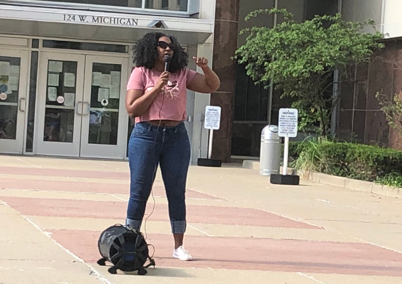 Natasha Atkinson, who claims Lansing Mayor Andy Schor fired her as a result of racial bias, speaks to a Black Lives Matter rally today in front of City Hall.