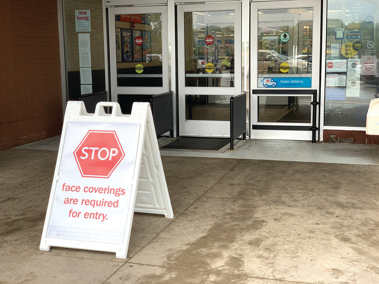 A sign at a Meijer store in Lansing warns customers to wear a mask while shopping.