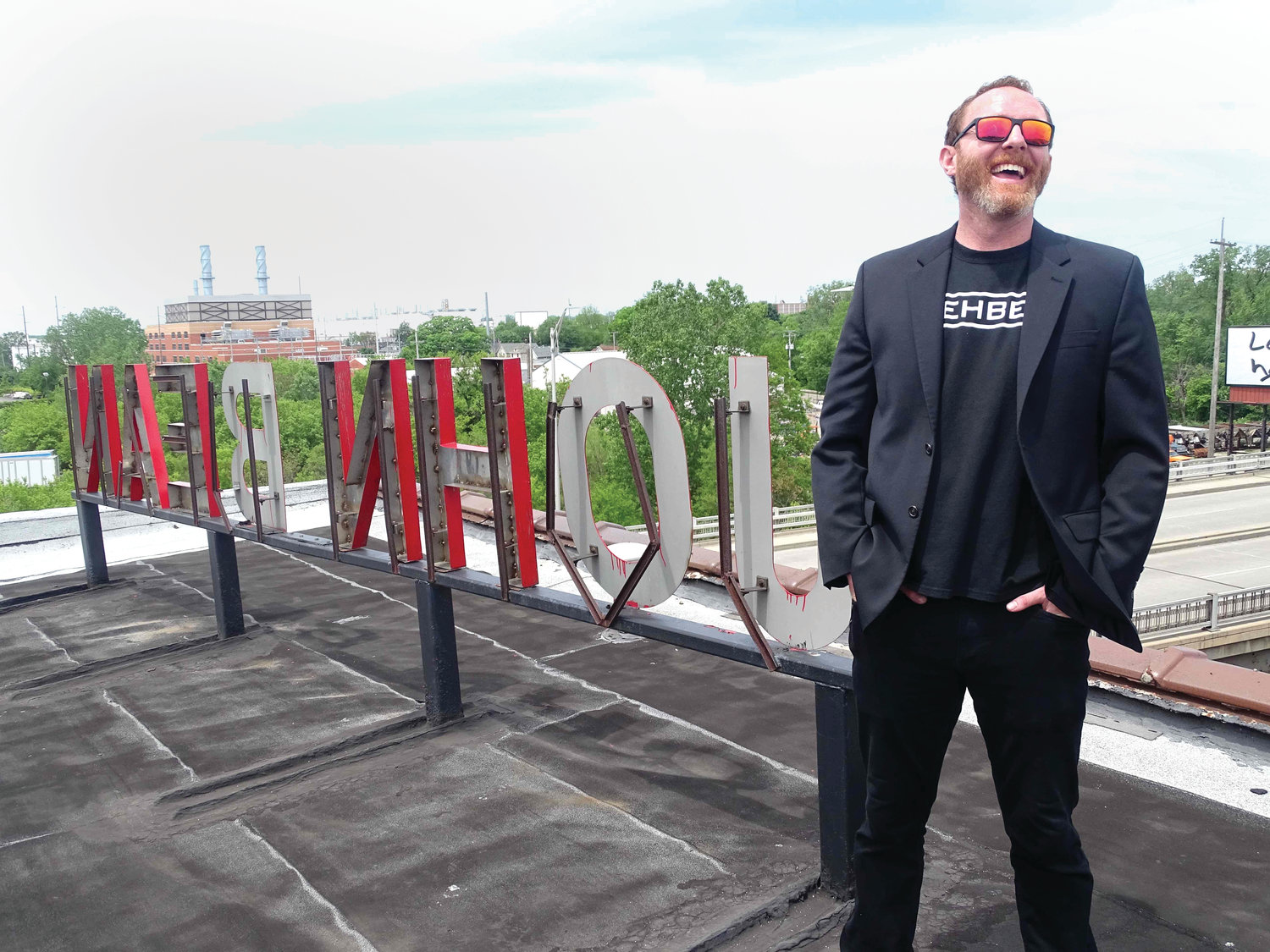 Michael Doherty, founder of Rehbel Industries, on the roof of the old John Bean Building, on South Cedar Street, which he is in the process of converting into one of the largest marijuana growing operations in the world.