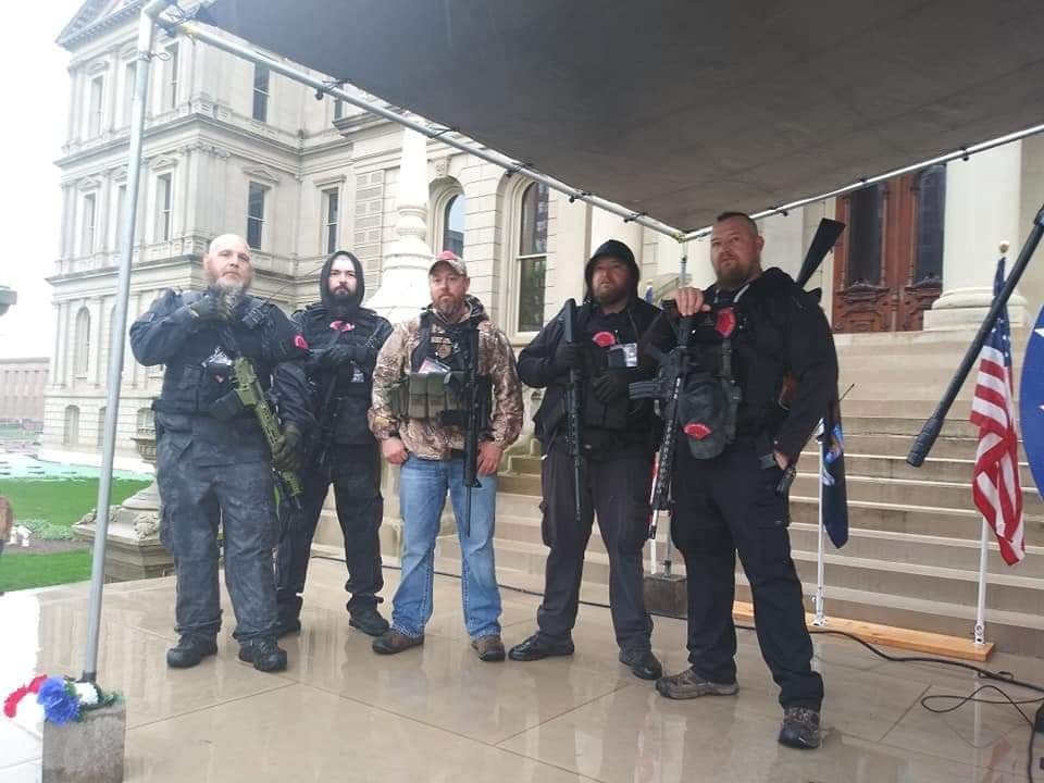 Five members of the Michigan Liberty Militia pose for a photo on the steps of the Capitol April 30 during protests against Gov. Gretchen Whitmer's lockdown orders. From left, MLM Commander Phil Robinson, two unidentified individuals, William "Bill" Null and Michael "Mike" Null, twin brothers from Plainwell and Shelbyville. The Nulls have been charged in the alleged plot against the governor.