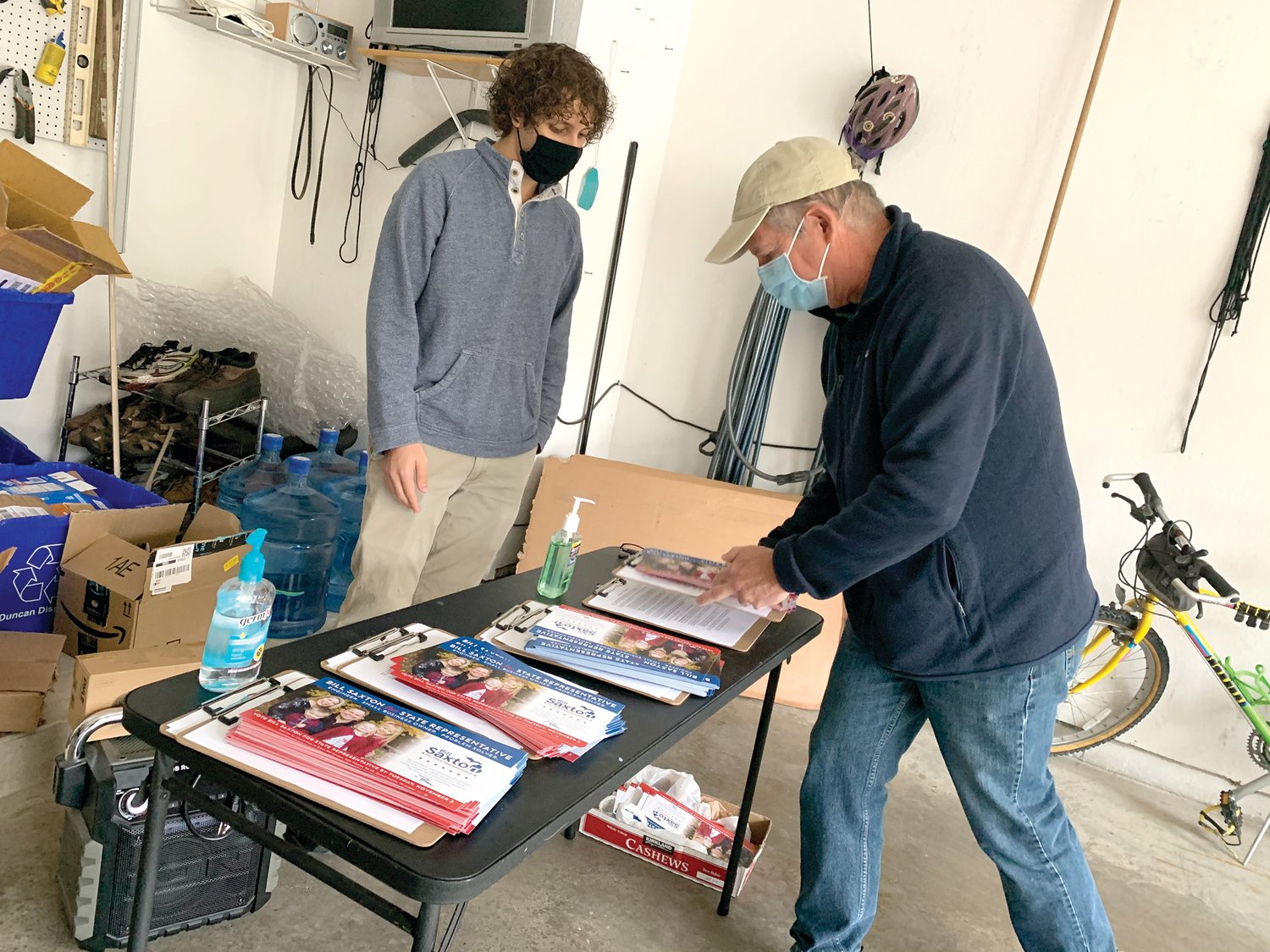 Samantha Schriber for City Pulse 
Canvassers for Democrat Bill Saxton meet in a Plainfield Township garage, preparing to go out for socially distant door knocking and to flip the Michigan 73rd State House District.