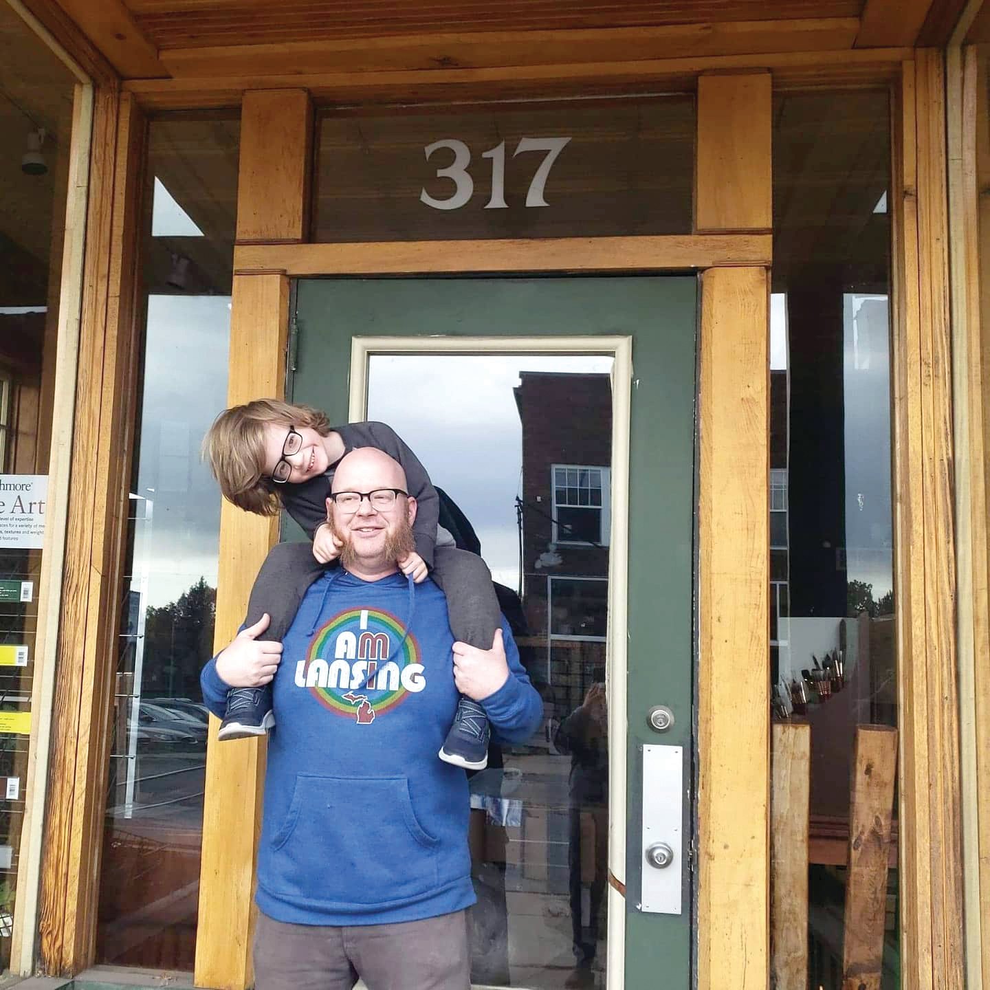 Odd Nodd Art Supply owner Casey Sorrow with his son in front of his new location at 317 Cesar E. Chavez Ave.