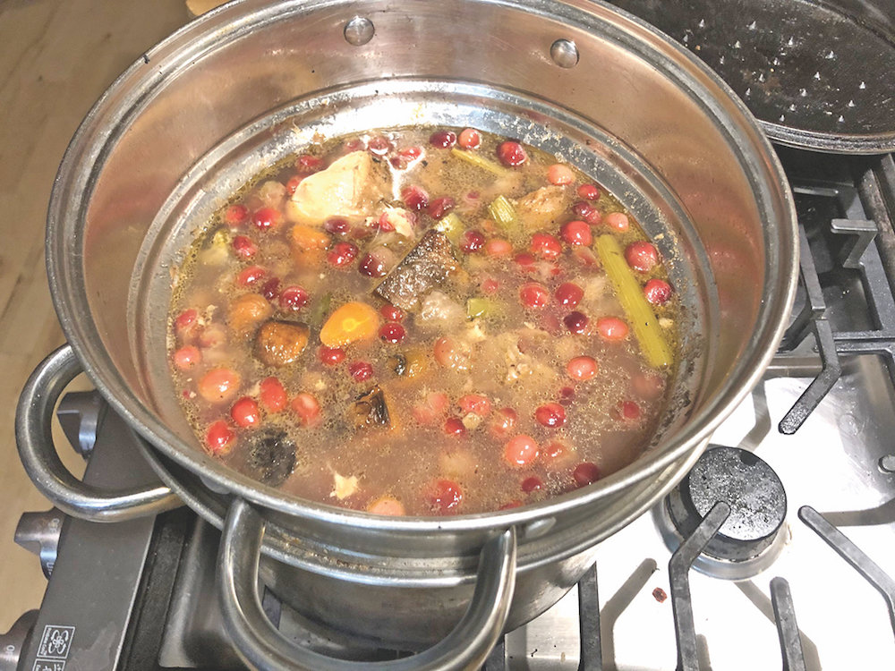 Ari LeVaux's homemade bouillon cooking on the stove.