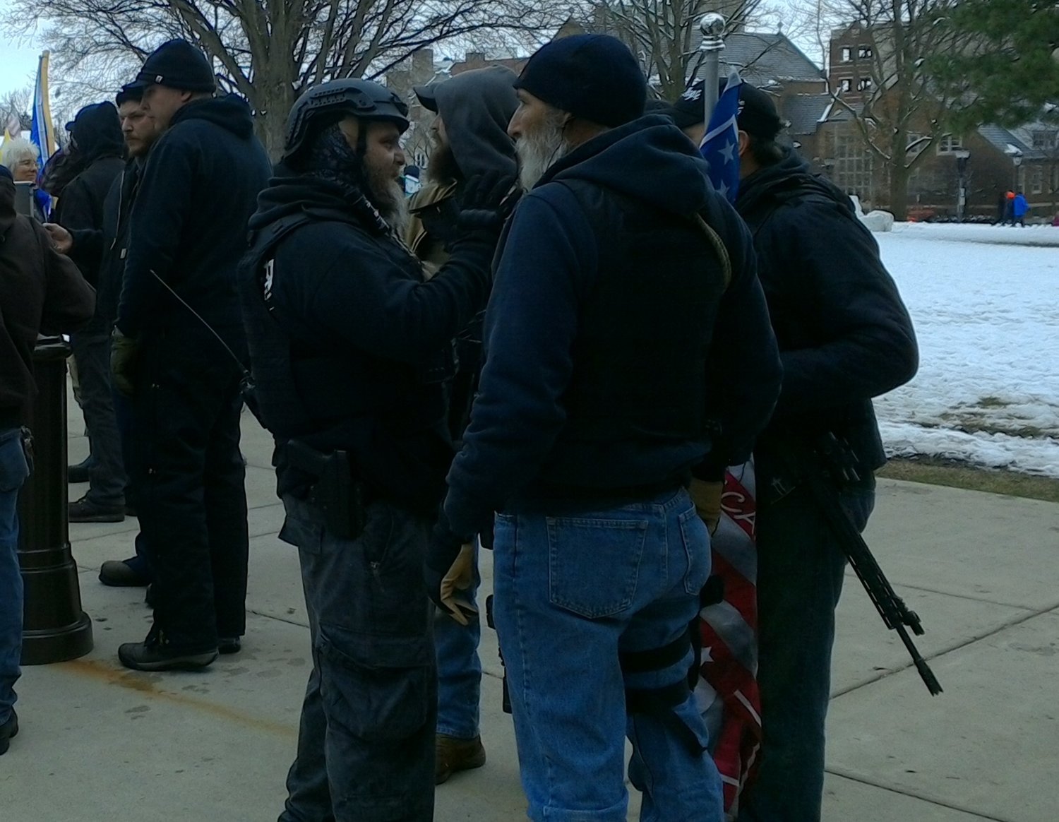 Phil Robinson, leader of the Michigan Liberty Militia, speaks with other Militia members at the Michigan Capitol on Wednesday during a pro-Trump rally and protest.