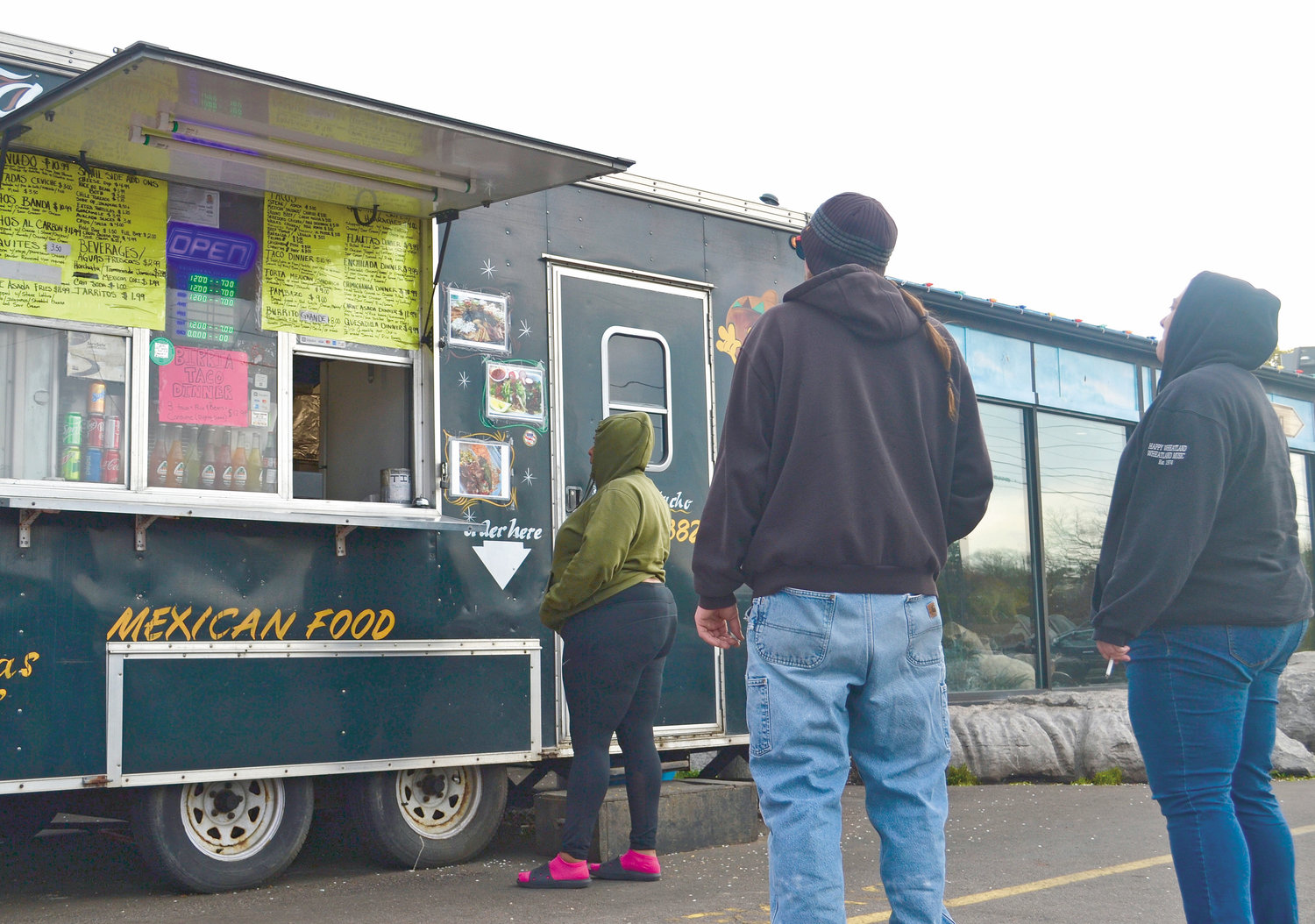Customers wait to order food at the Taquero Mucho food truck on Cedar Street.