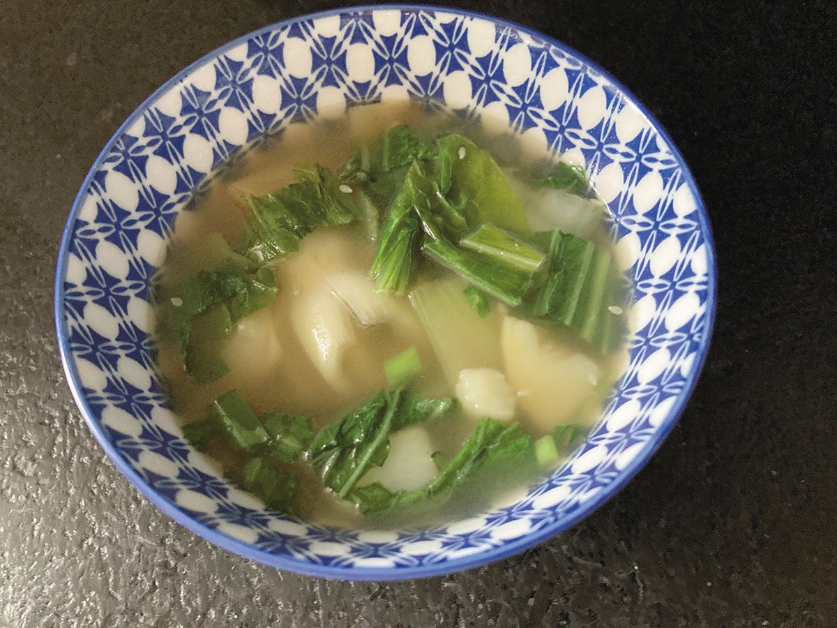 Bok choy and potato soup, with a whole bok choy core visible.