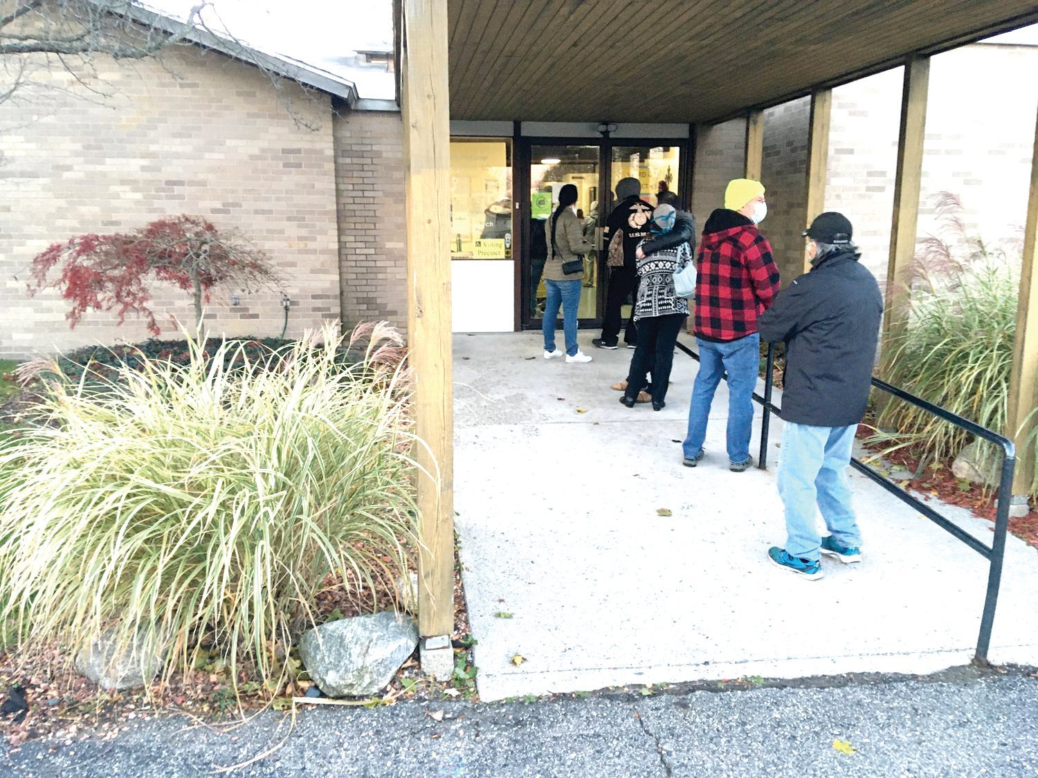 Voters stand in line early morning on Election Day 2020 at St. Stephen’s Lutheran Church in Delta Township.