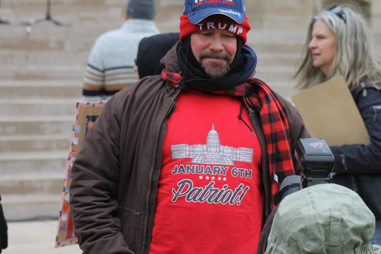 A man poses with a "Jan. 6 Patriot" shirt.