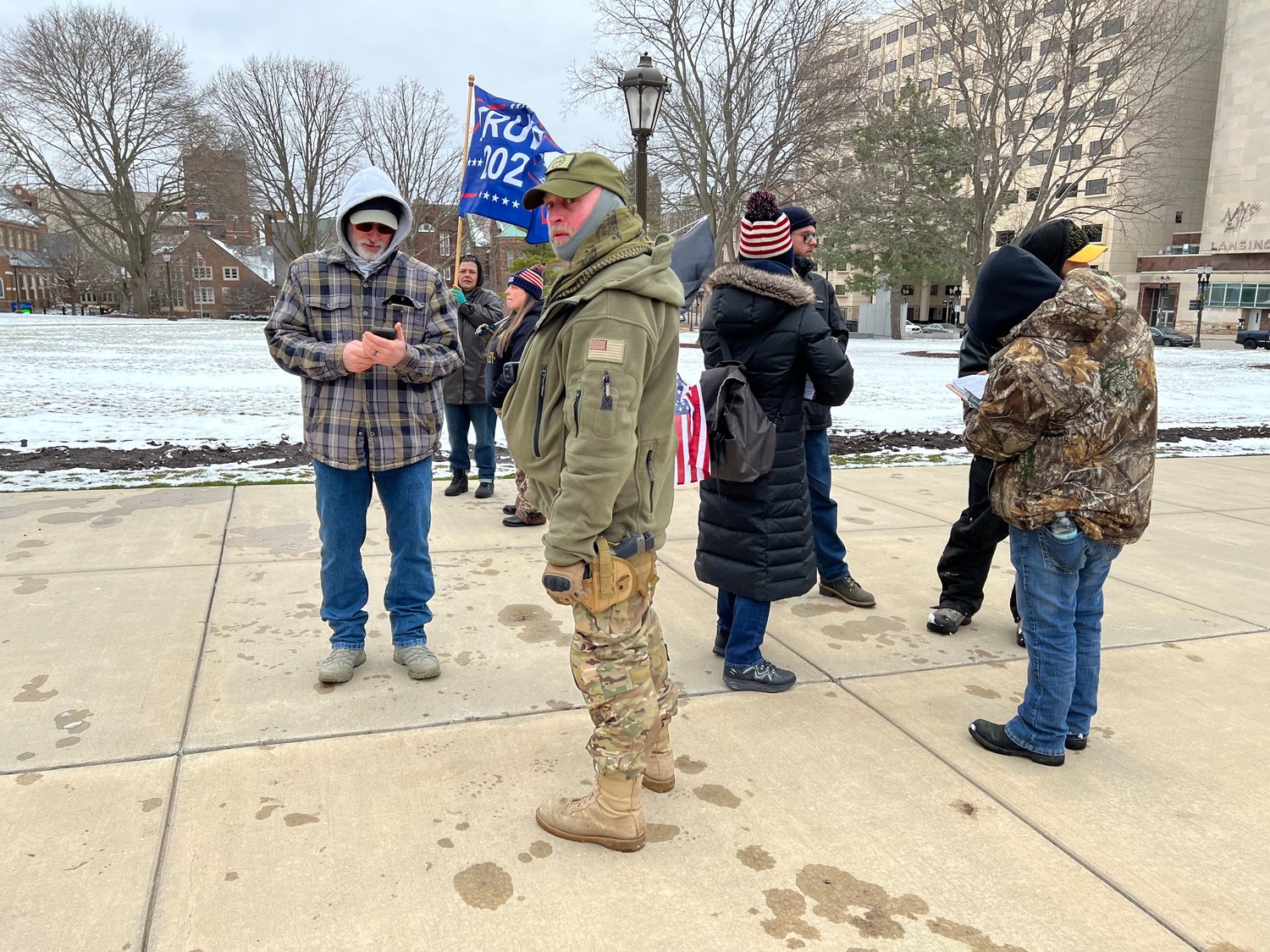 One man, pictured in the camouflage with a firearm at his side, identified himself as "head of security" at the rally and demanded this photo be deleted.