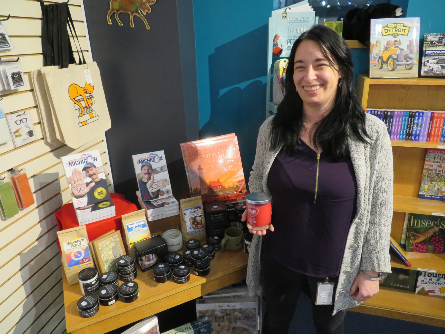 Michigan History Center and Library of Michigan Gift Shop manager 
Kay Ann Schlang is surrounded by hundreds of Michigan-made products, including the Howell-made Faygo pop candle in her hand.
