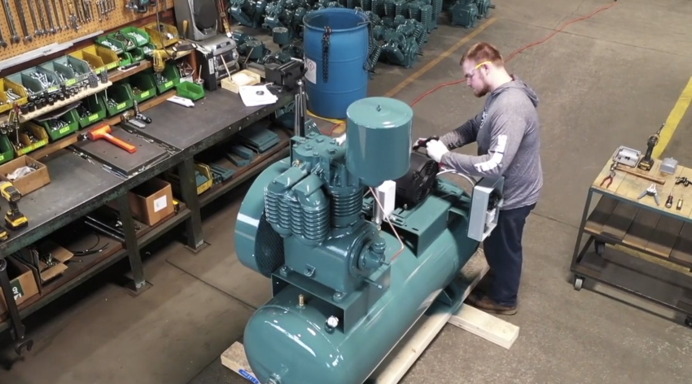 A worker puts a shine on a brand-new Saylor-Beall air compressor, manufactured in St. Johns.