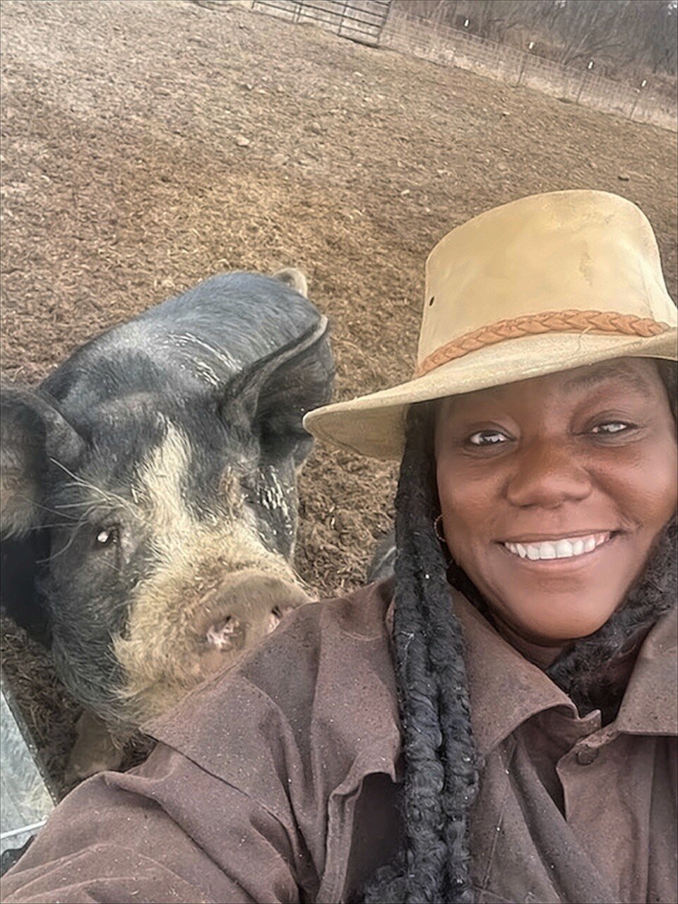 Shara Trierweiler cavorts with her 1,200-pound Berkshire boar, Big John, the herd sire at Agape Organic Farms in Dansville.