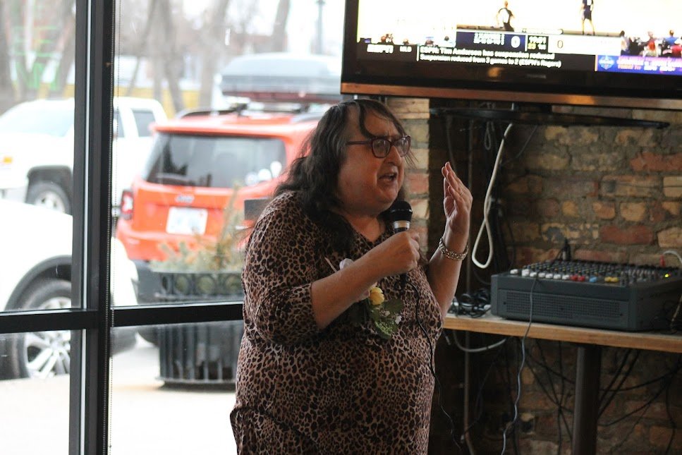 Rachel Crandall-Crocker, a former Lansing resident, leader of Transgender Michigan and founder of the International Transgender Day of Visibility, greets attendees at an impromptus celebration of the day at Sir Pizza in Lansing.