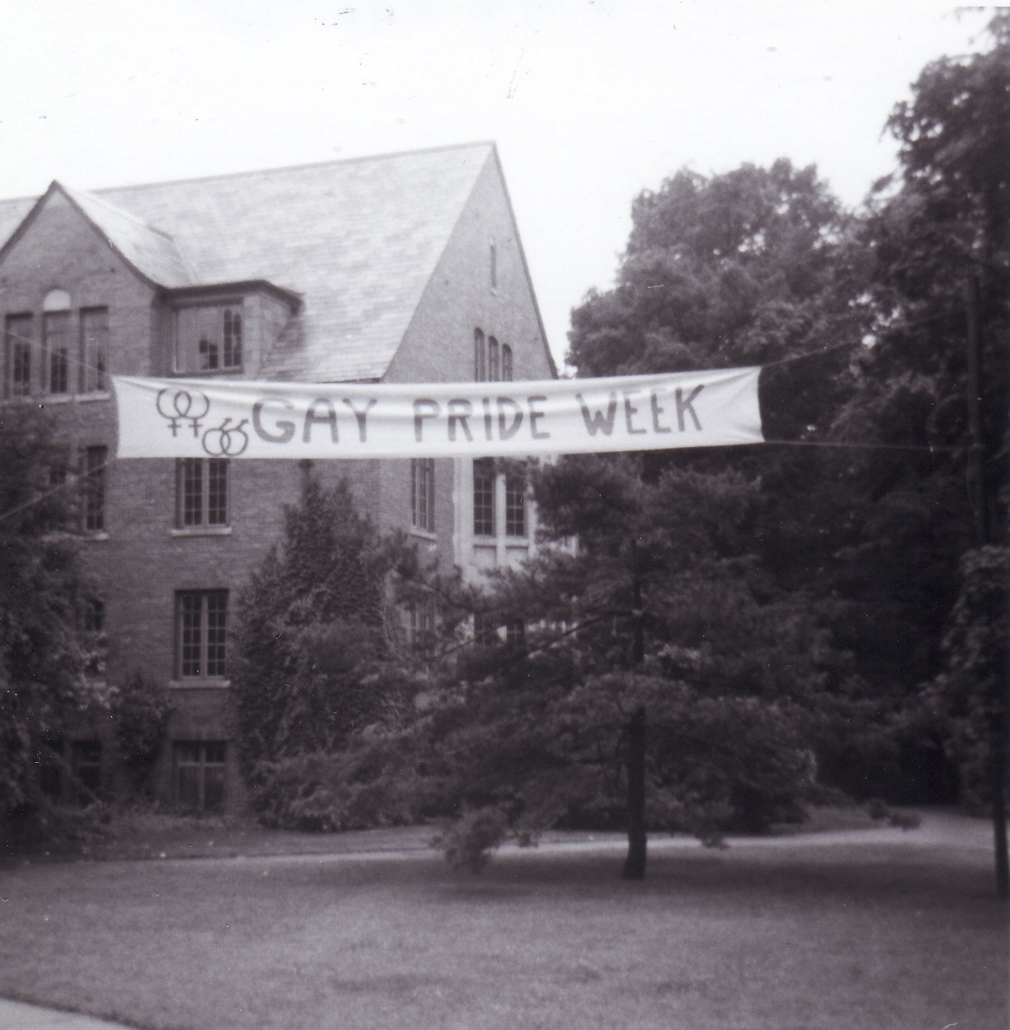 Gay Pride Week banner at the MSU Abbot Road entrance in 1973, a year after school officials denied permission to display the banner. From private collection of Greg Kamm.