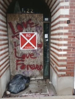 Once the entrance to hotel, this door features a red tag attesting to the deplorable conditions inside and out of the old Neller Building.
