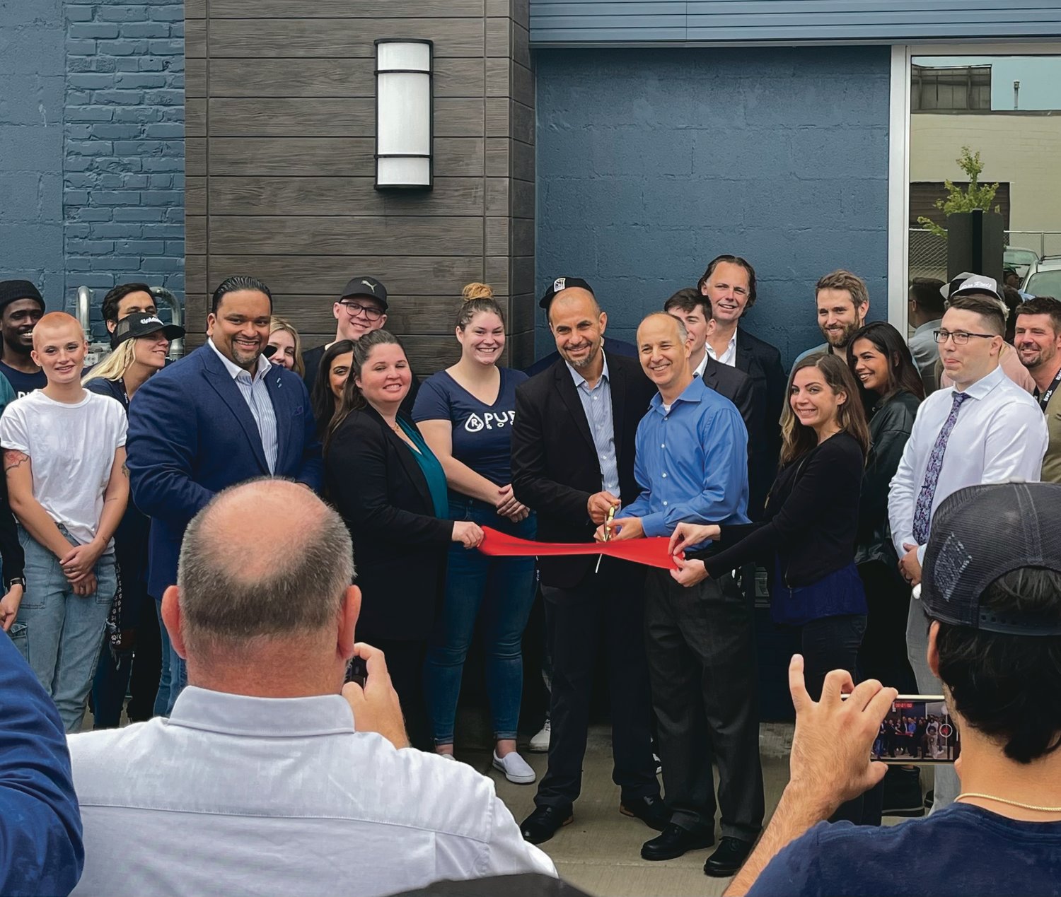 Lansing Mayor Andy Schor cuts the ribbon Tuesday (Sept. 20) at Pure Roots’ grand opening event at its new location Tuesday (Sept. 20) at 515 N. Larch St.