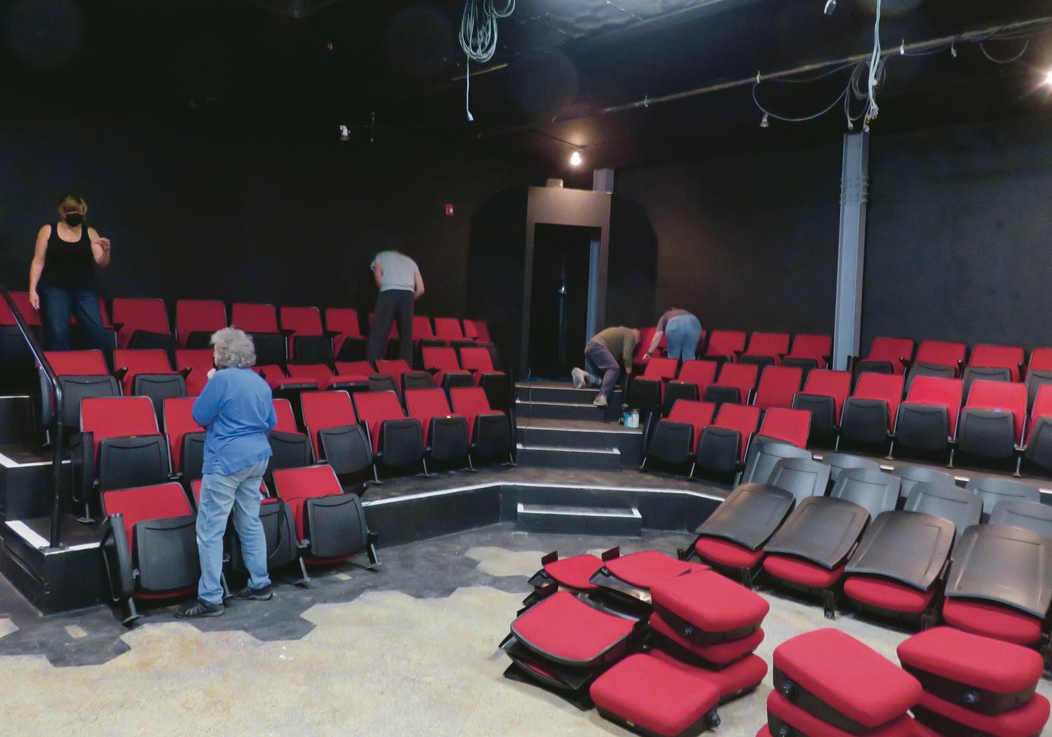 Williamston Theatre executive director Emily Sutton-Smith (upper left) and her colleagues painted the theater. They bolted down seats over the weekend to prepare for the Oct. 13 opening night of “Magnolia Ballet, Part One.”