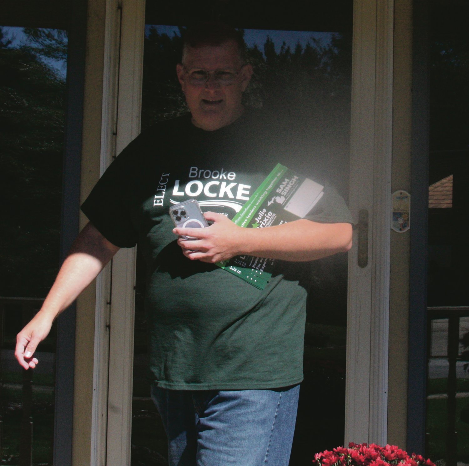 Brooke Locke, the Democratic candidate for the Ingham County Commission 15th District, leaves a porch after contacting voters.