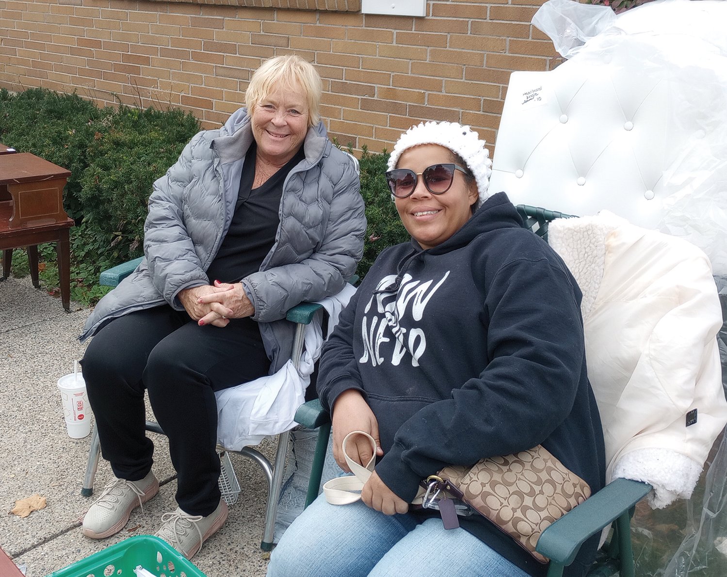 Gayle Thompson (left) and her daughter Vanessa McDaniel were overseeing a garage sale when asked to discuss a $175 million bond proposal on the ballot in November to build a new public safety facility and improve conditions of three fire stations in Lansing.