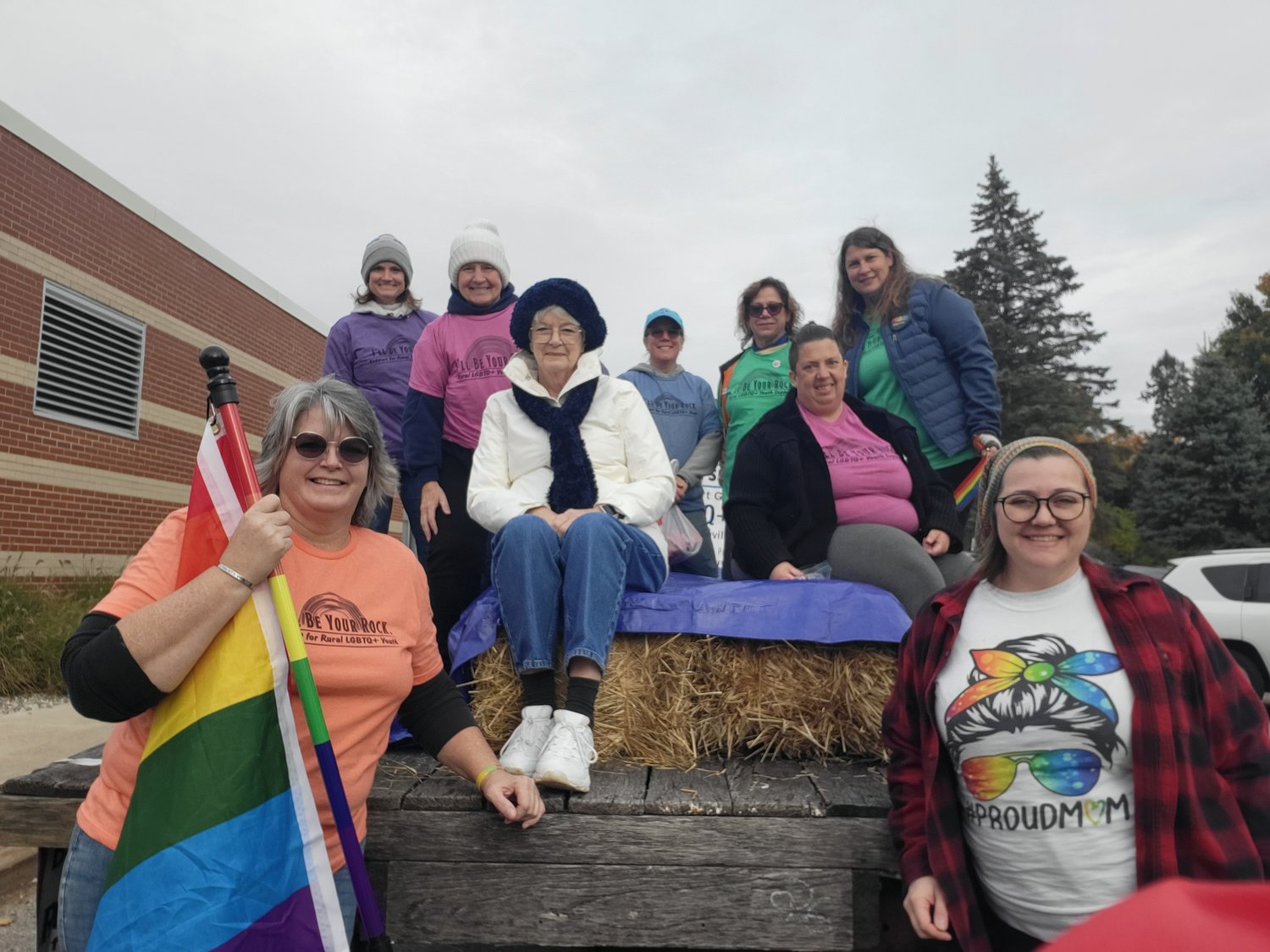 Christine Terpening (left), president of I’ll Be Your Rock, and Vice President Kallie Strouse, pose with the rest of the adults who rode on the organization’s float in the Maple Valley School District’s homecoming parade Friday (Oct. 14).