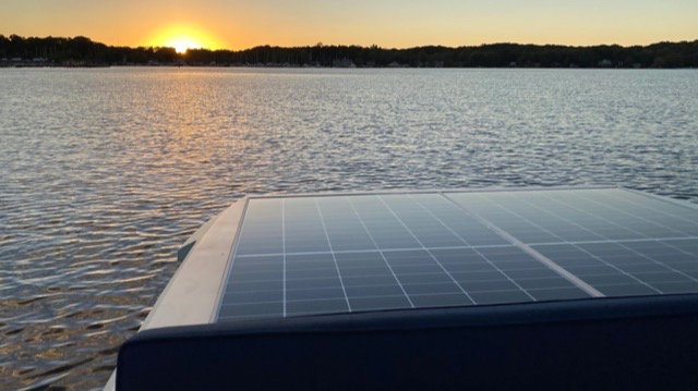 A solar panel at sunset in a Lilypad boat on the Kalamazoo River. A fully charged boat can run all night.