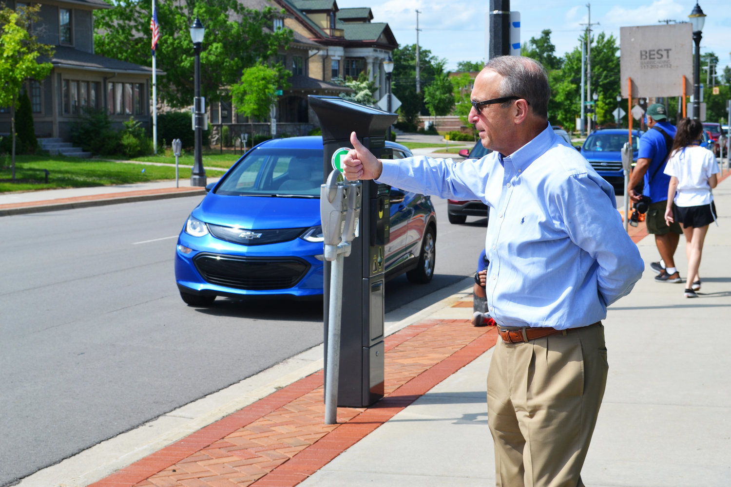 Brent Knight says goodbye to well-wishers during a surprise farewell parade on Capital Avenue in 2020 as he ended 12 years as president of Lansing Community College.