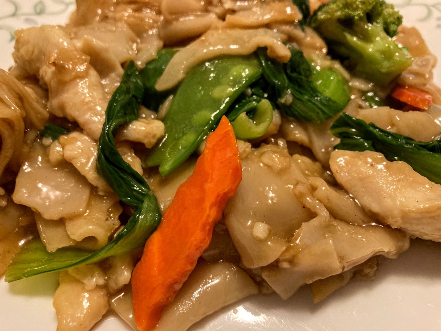 Ho fun noodles with chicken and vegetables slathered in an umami gravy sauce.