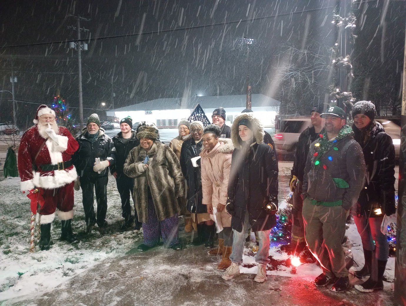 Santa Claus and Lansing residents gathered in the snow to sing carols and light the holiday lights in the Plaza located at the corner of Pleasant Grove Rd. and Holmes Rd. in southwest Lansing. The event was sponsored by Southwest Lansing Action Group (SWAG).