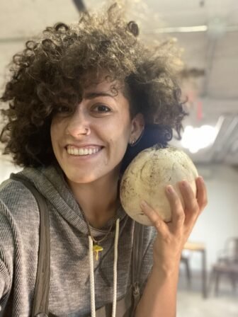 Foraging expert Gabrielle Cerberville holds up a giant puffball, one of many edible mushrooms growing in the Great Lakes region.