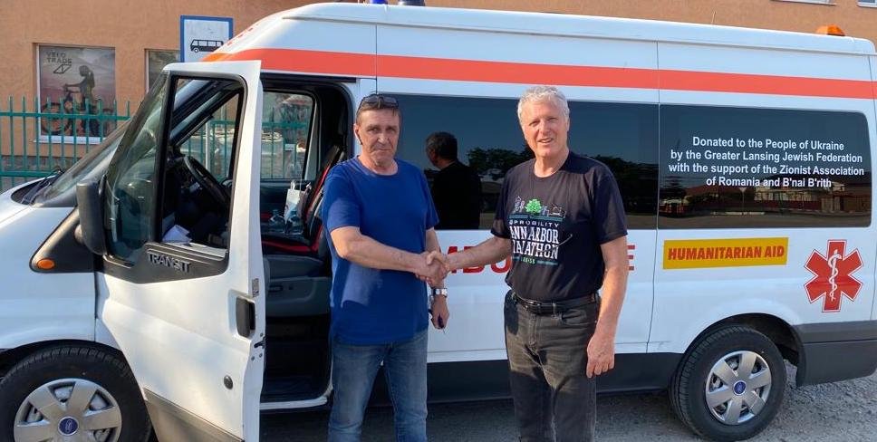 Ody Norkin (right) delivers an ambulance in Vynohradiv, Ukraine, for Dnipro, Ukraine, donated by the Greater Lansing Jewish Federation.