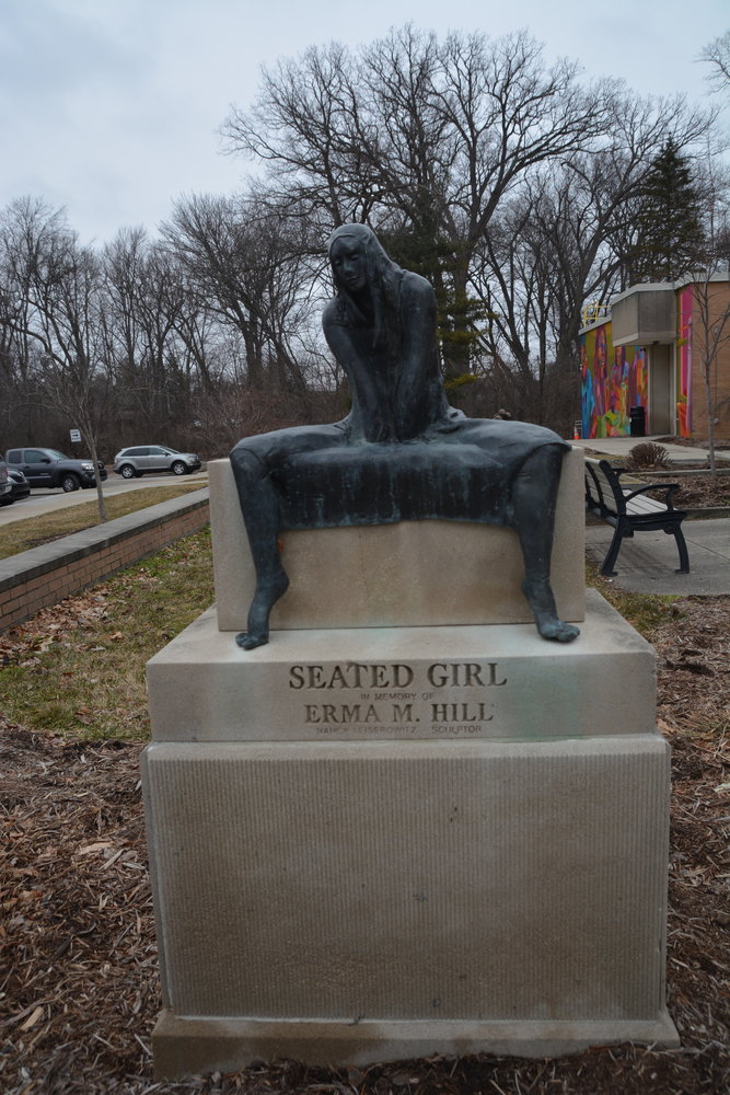 Two sculptures, “Who’s Watching Whom,” by Jane DeDecker, and “Seated Girl,” (above) by Nancy Leiserowitz, greet guests as they enter.