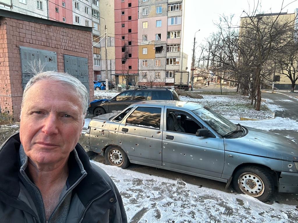 Ody Norkin near a bullet-ridden car in Irpin, Ukraine, on his latest trip. “People were trying to escape,” Norkin said, “and they just take a Kalashnikov and spray them with bullets. I’m there a year later, and I see more than 100 cars like that in one lot. I can’t tell you how many victims there must have been.”