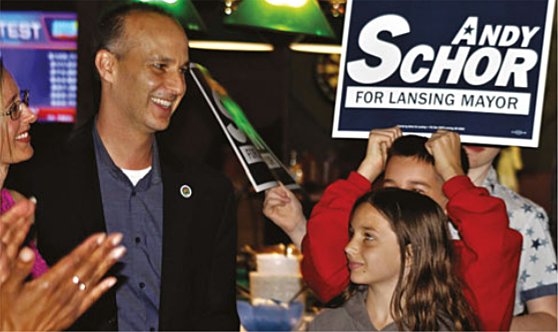 Andy Schor celebrating his mayoral nomination primary election victory in 2017 with his wife, Erin, and his children, Hannah,  then 11, and son Ryan, then 13, holding the campaign sign.